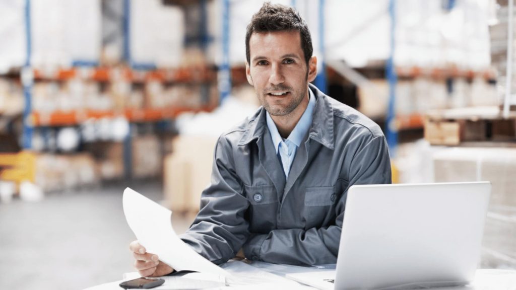 best distribution warehouse personnel sitting at desk with computer